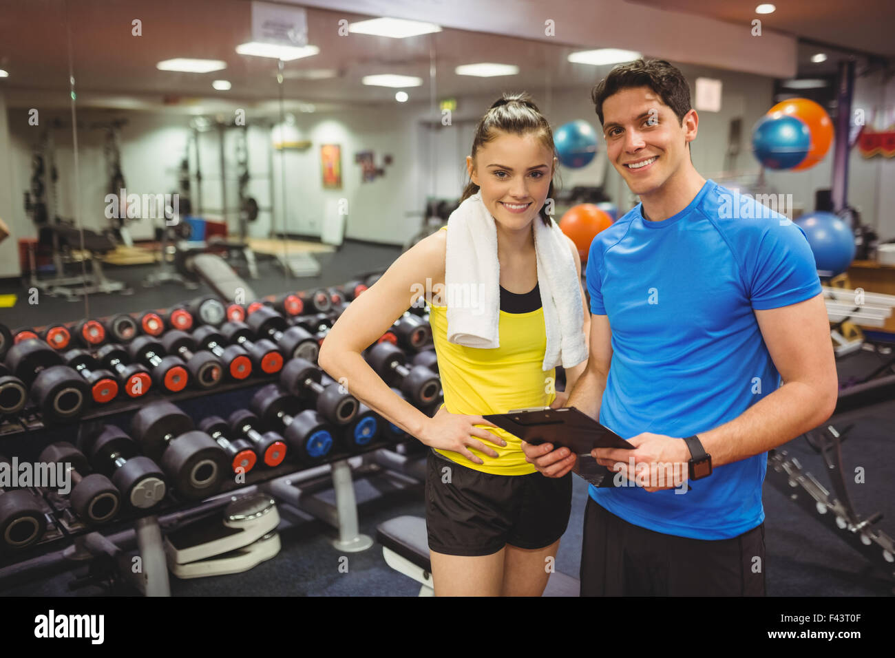Trainer And Client Trainer and client discussing her progress Stock Photo - Alamy