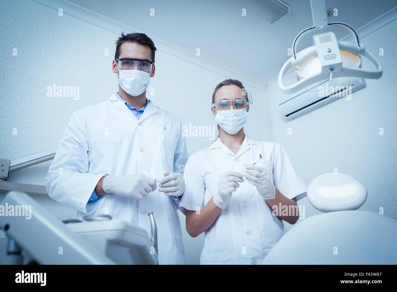 Female coworkers wearing masks hi-res stock photography and images - Alamy