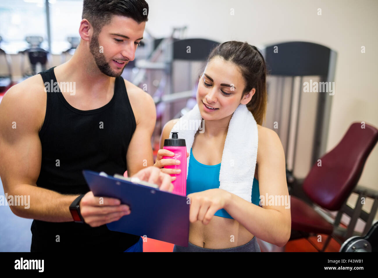 Trainer explaining workout regime to woman Stock Photo
