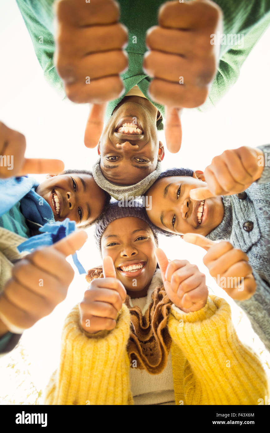 Young family doing a head circles with thumbs up Stock Photo