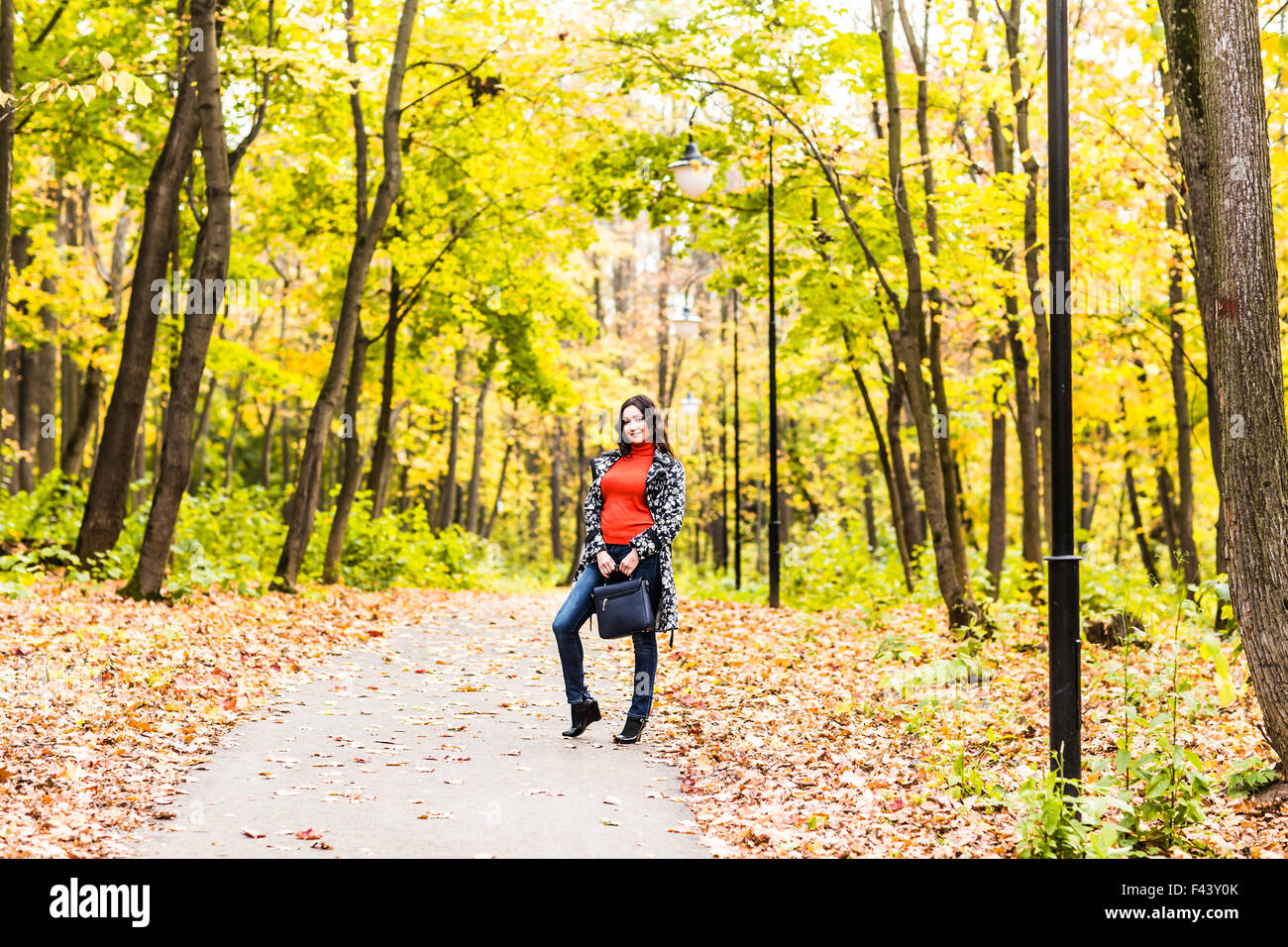 Beautiful woman in autumn park Stock Photo - Alamy