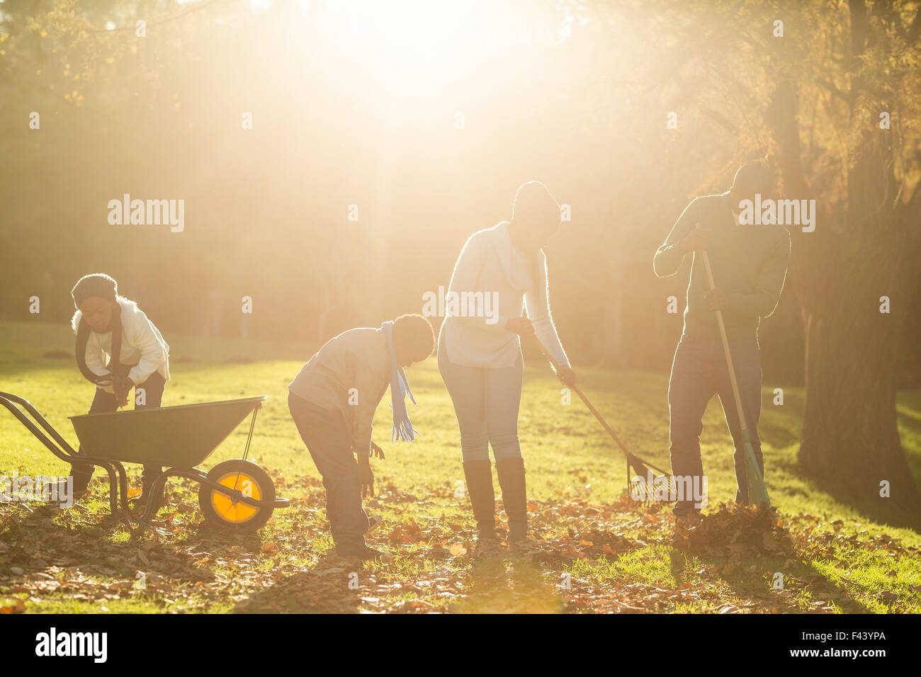 Young family picking up leaves Stock Photo