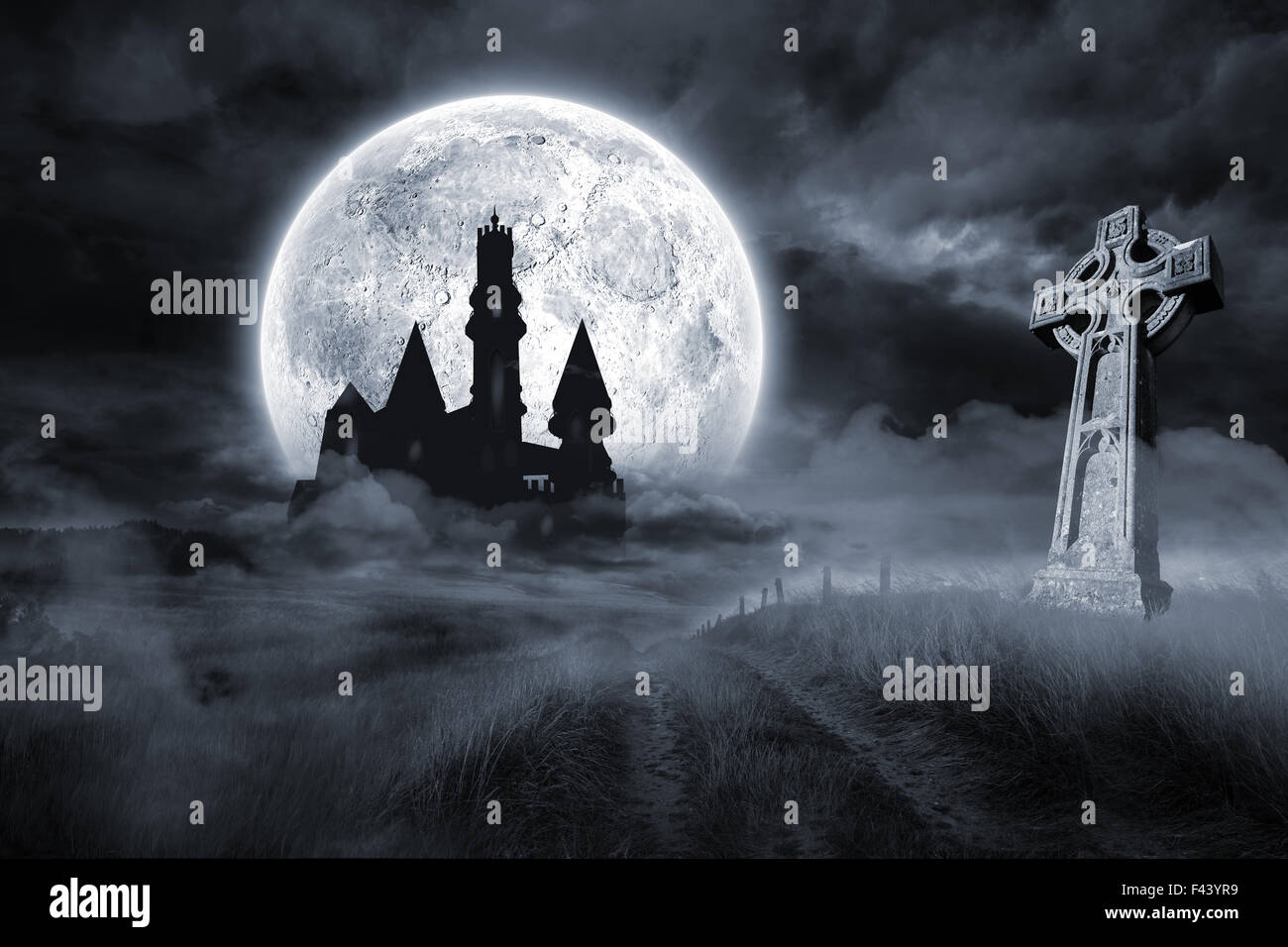 Castle and grave under full moon Stock Photo