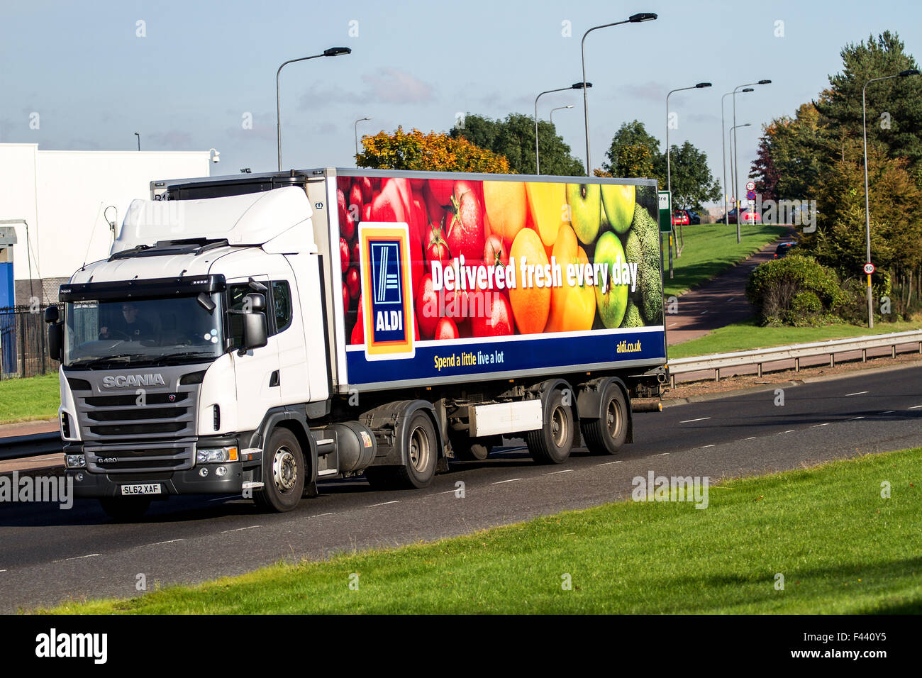 Panning an Aldi articulated lorry travelling along the Kingsway West Dual Carriageway in Dundee, UK Stock Photo
