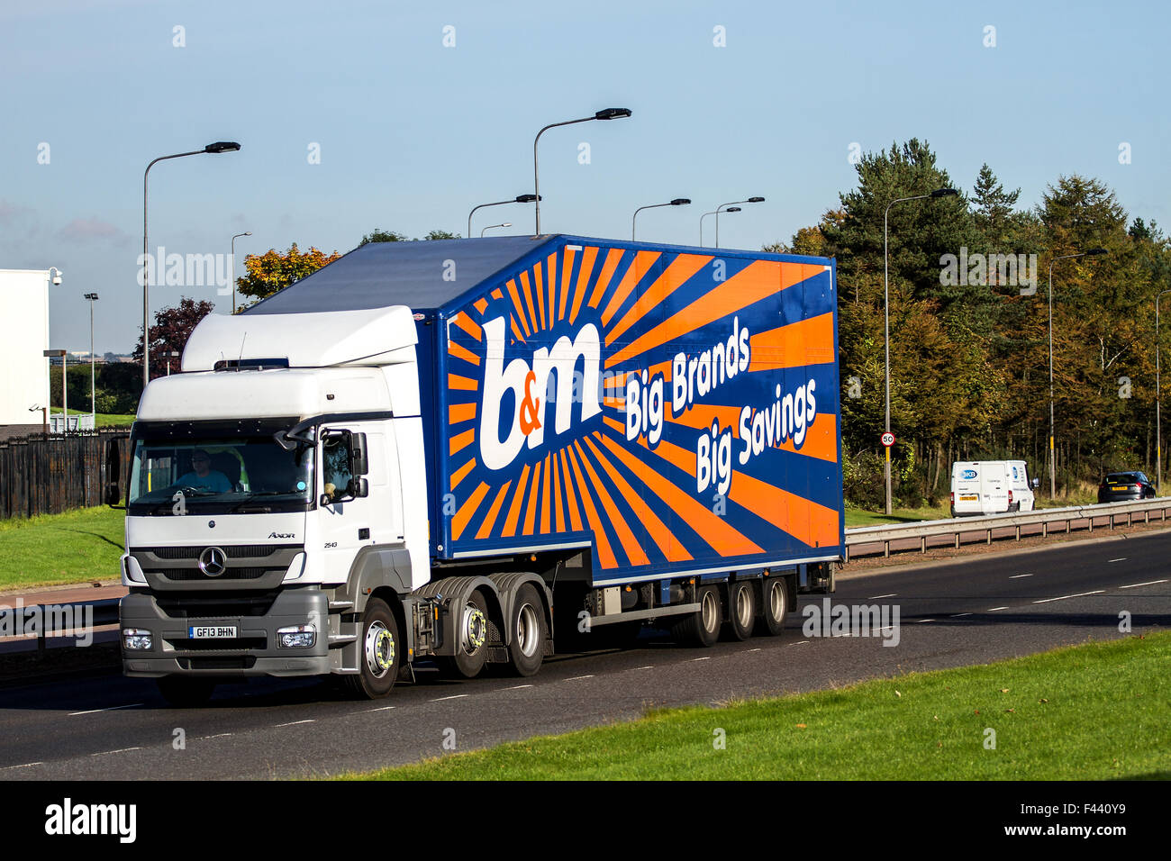 Panning a B&M Bargains articulated lorry travelling along the Kingsway West Dual Carriageway in Dundee, UK Stock Photo
