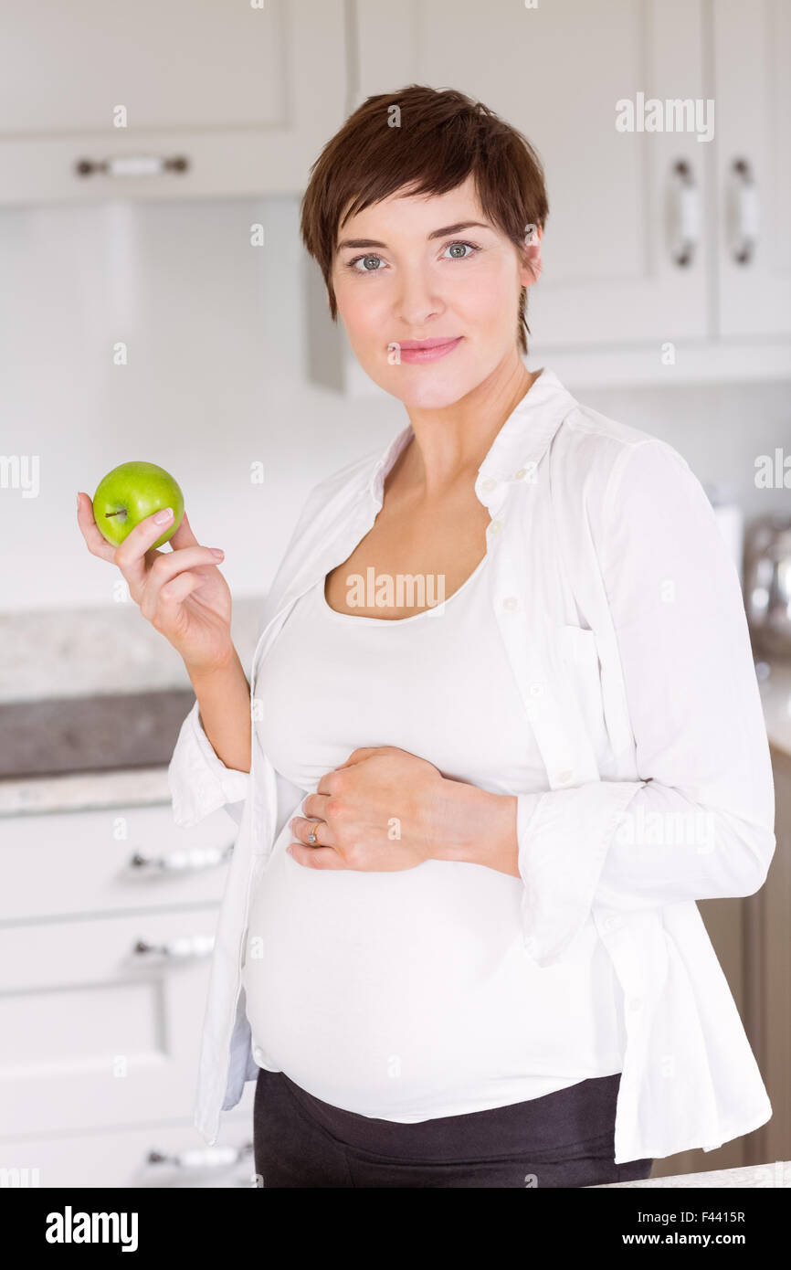 Pregnant woman eating an apple Stock Photo Alamy