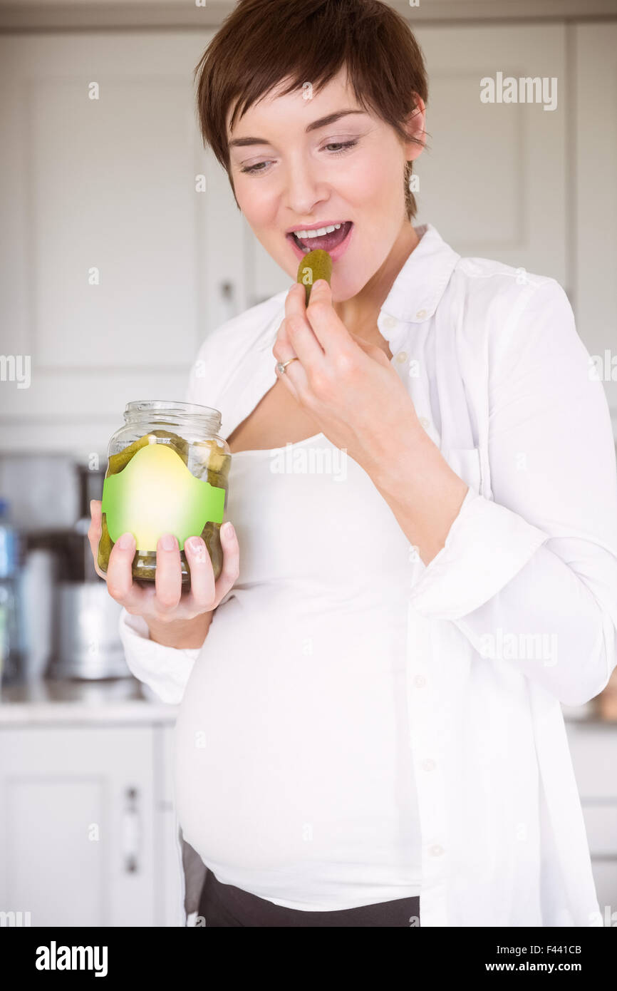 Pregnant woman eating jar of pickles Stock Photo Alamy