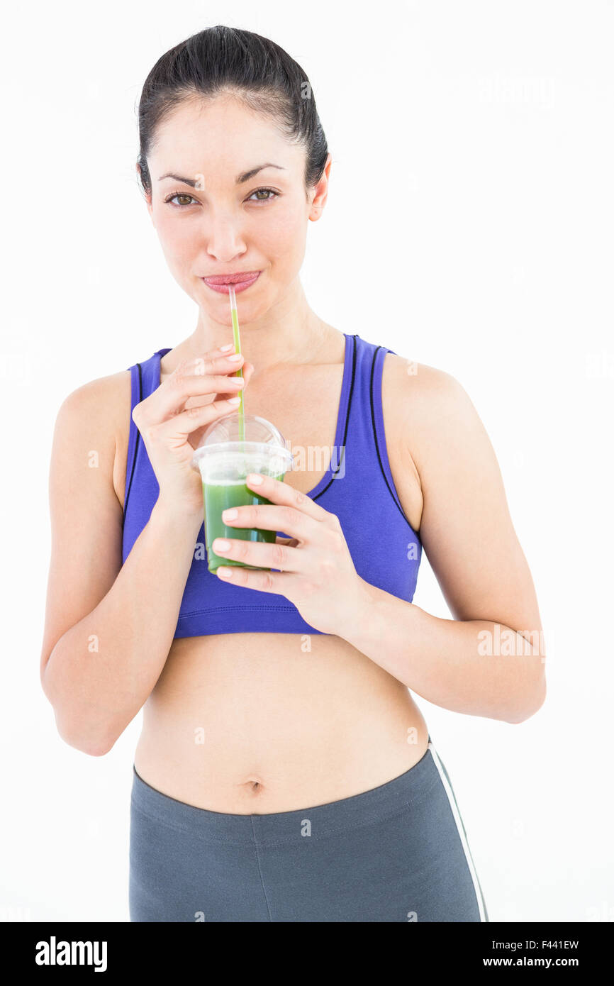 Attractive woman drinking green juice Stock Photo Alamy