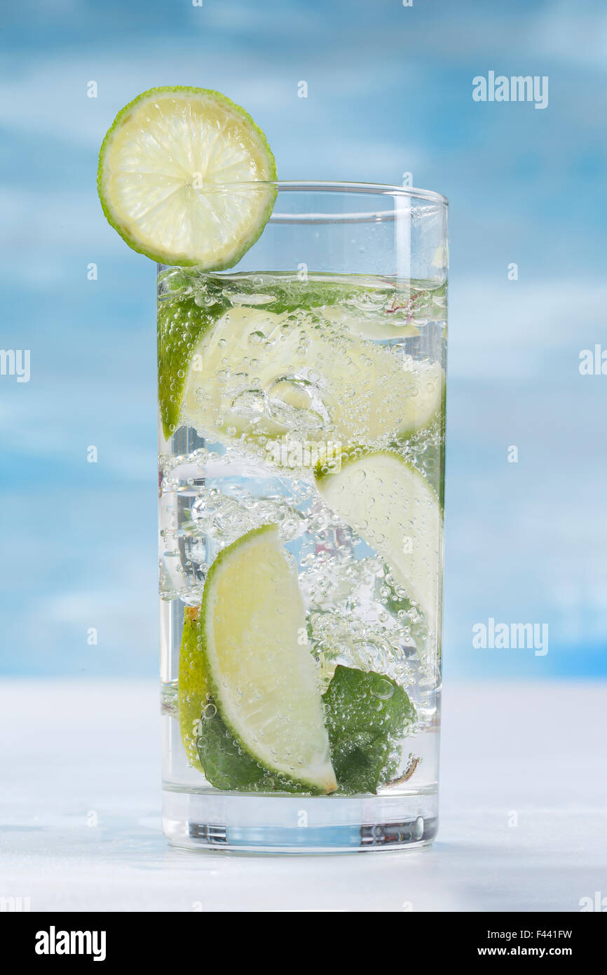 Glass of sparkling water with ice cubes Stock Photo - Alamy