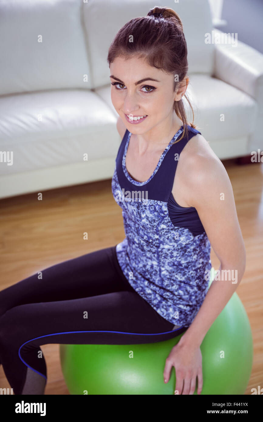 Fit woman sitting on exercise ball Stock Photo - Alamy