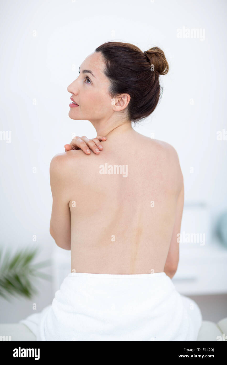 Woman touching her shoulder Stock Photo - Alamy