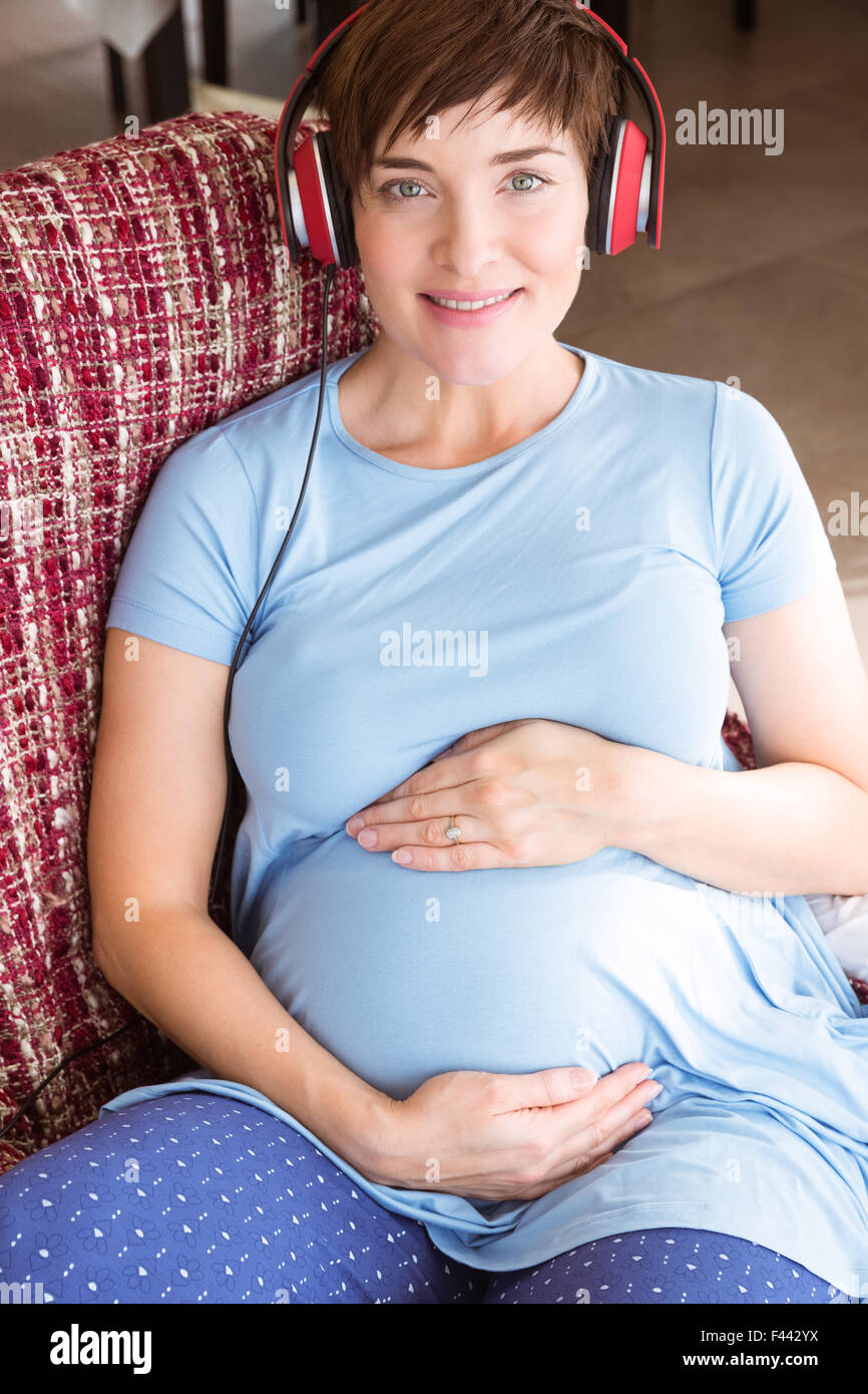 Pregnant woman listening to music Stock Photo - Alamy