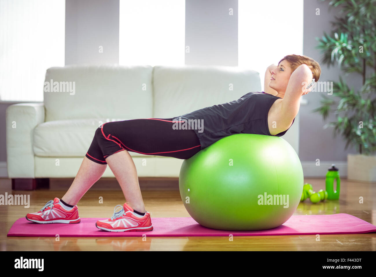 Fit woman doing sit ups on exercise ball Stock Photo - Alamy