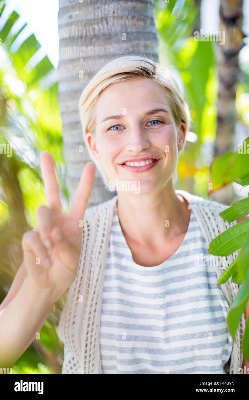 Pretty blonde woman smiling at the camera Stock Photo - Alamy