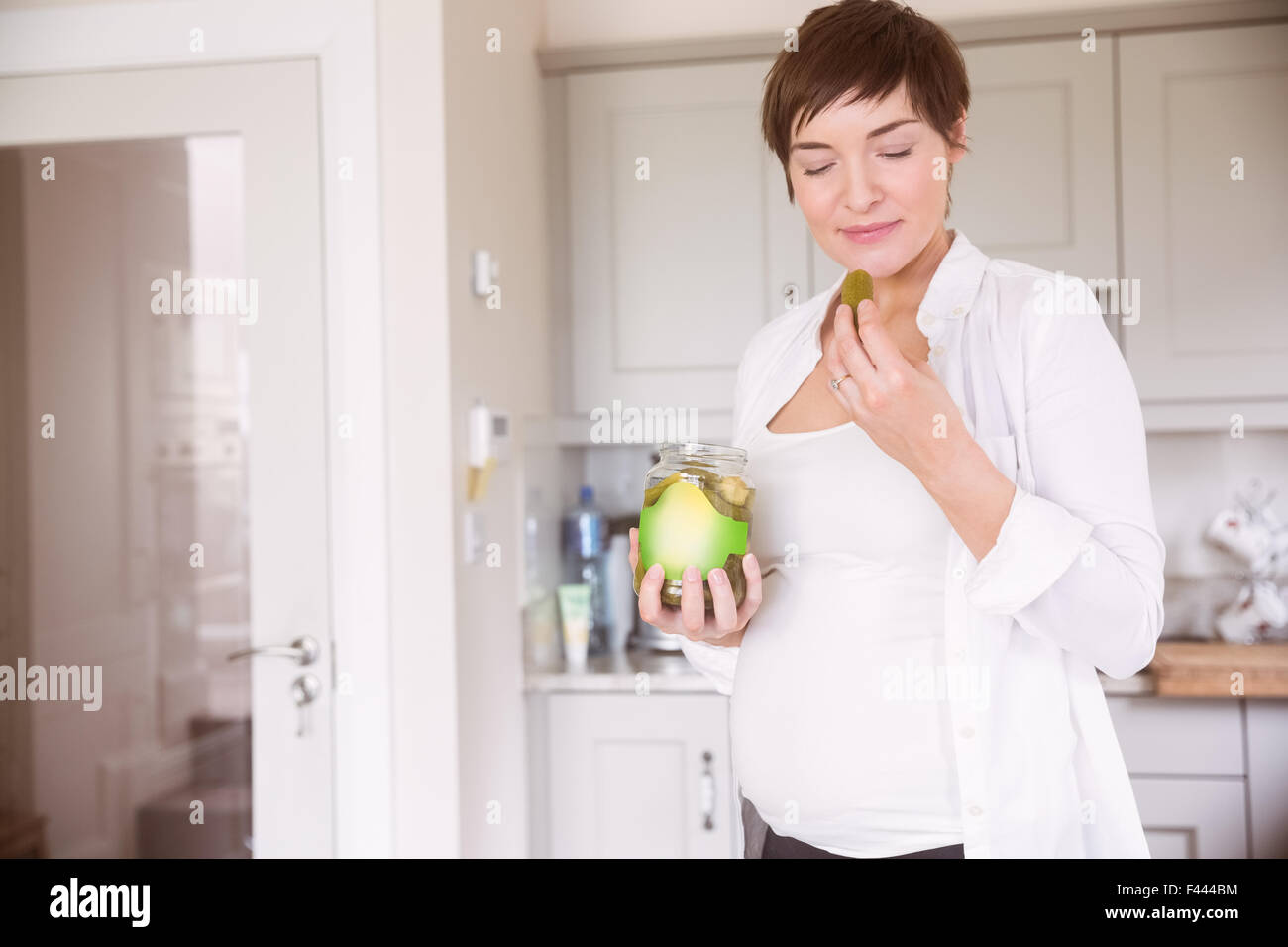 Pregnant woman eating jar of pickles Stock Photo Alamy