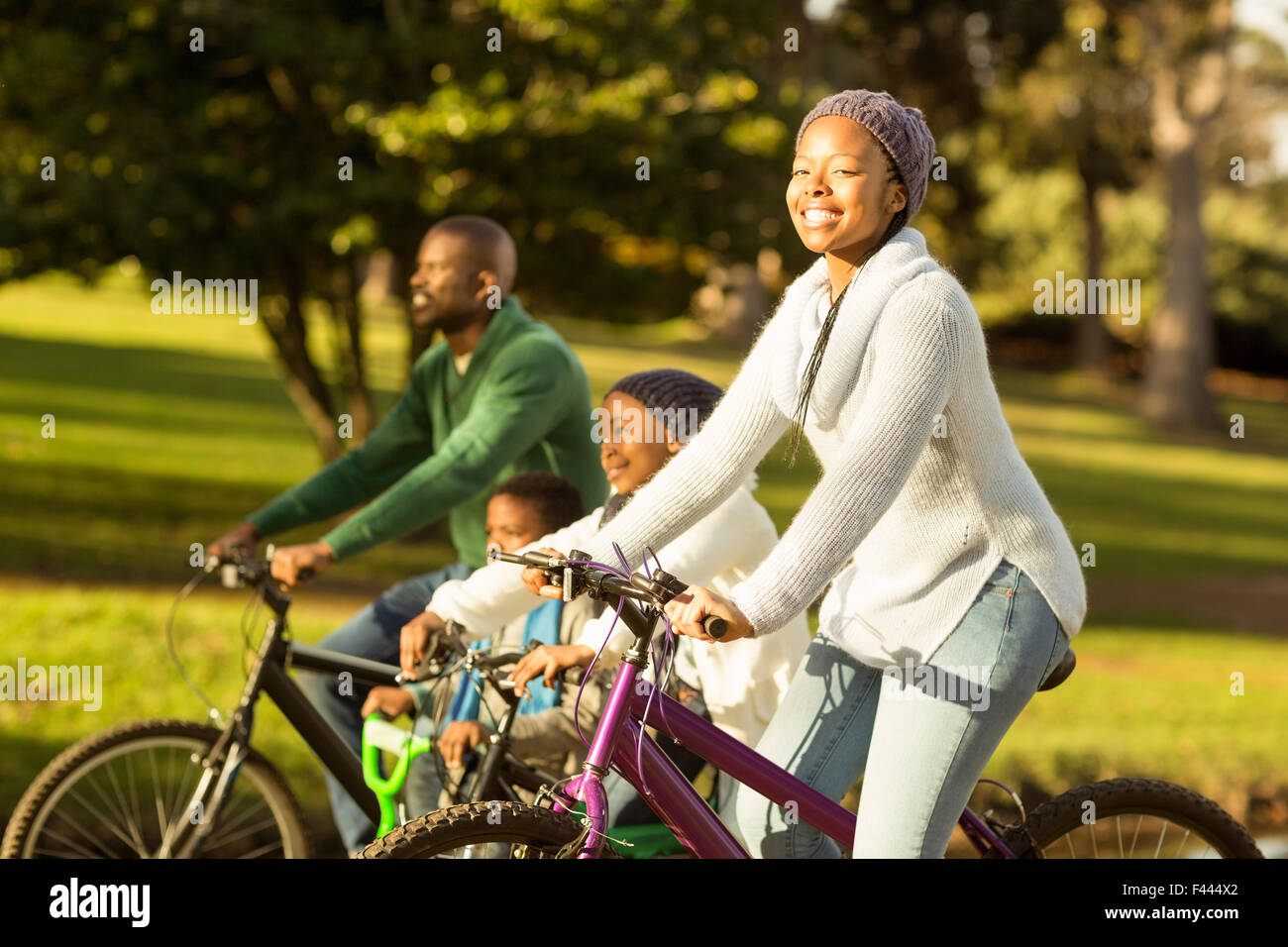 Side view of a young family doing a bike ride Stock Photo