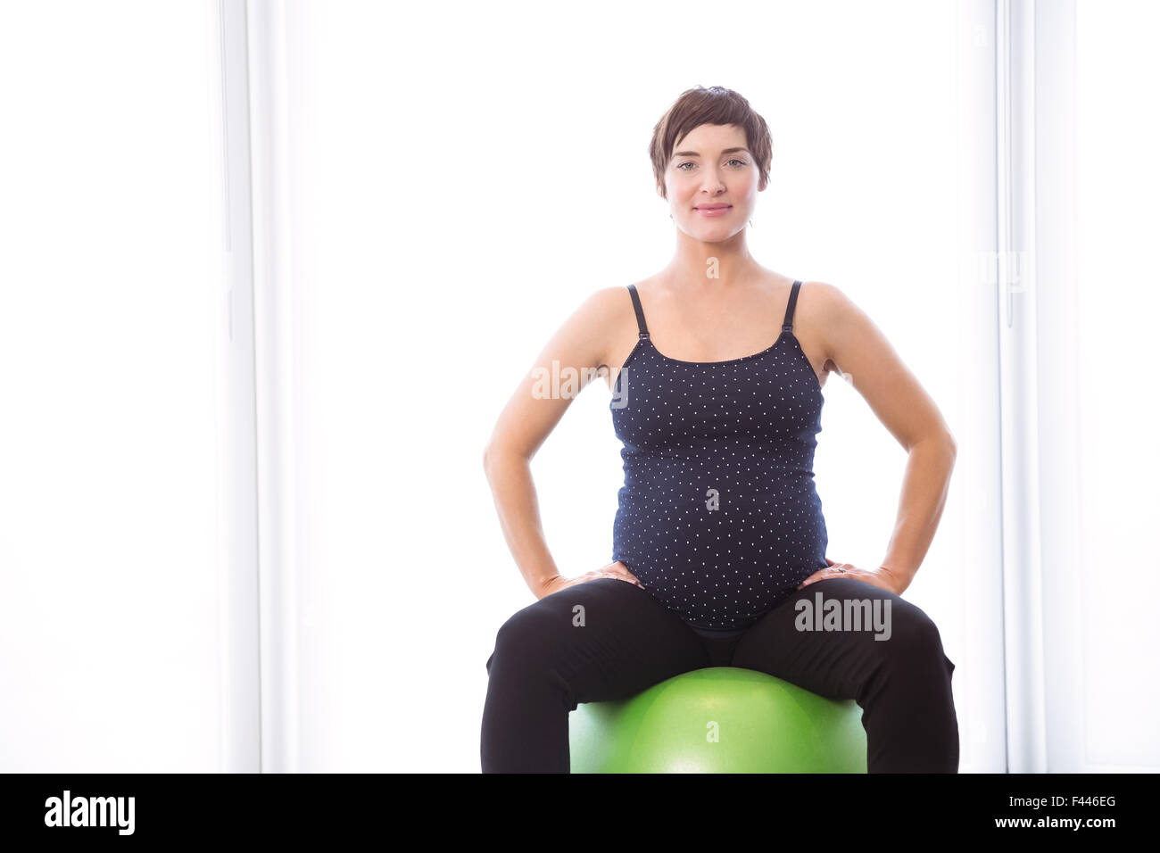 Pregnant woman keeping in shape Stock Photo