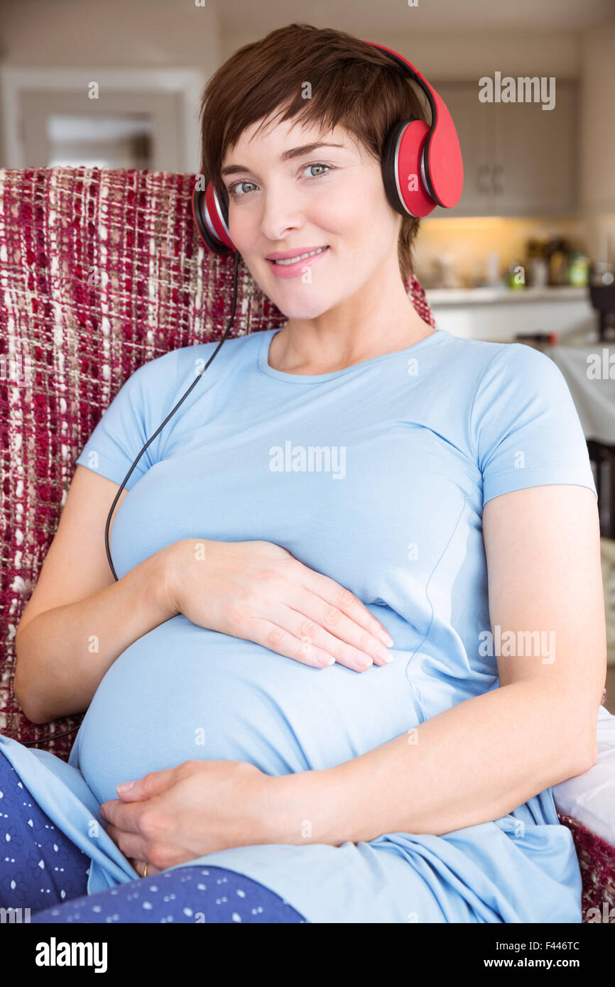Pregnant woman listening to music Stock Photo - Alamy