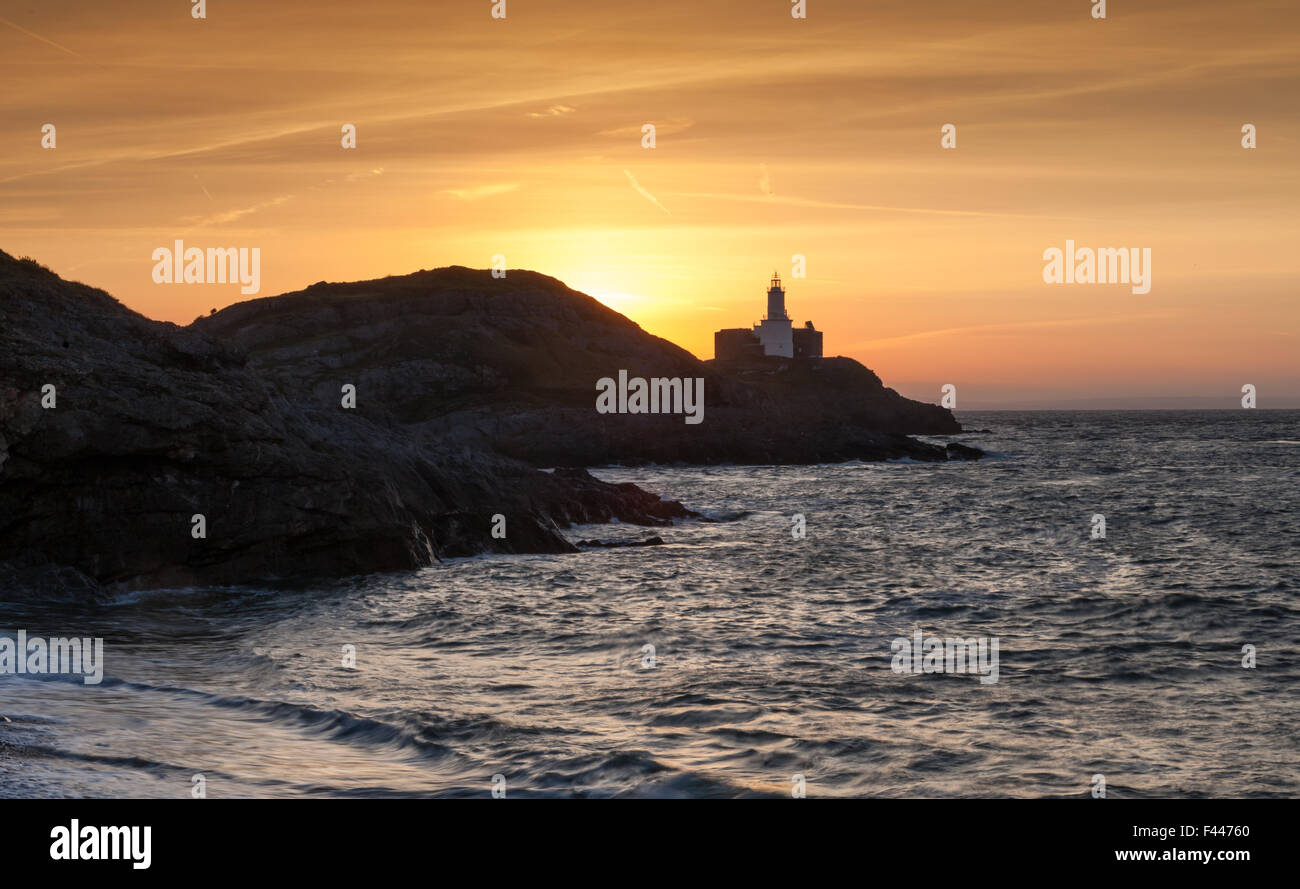 Dawn at Mumbles Lighthouse, Swansea, shot from Bracelet Bay Stock Photo