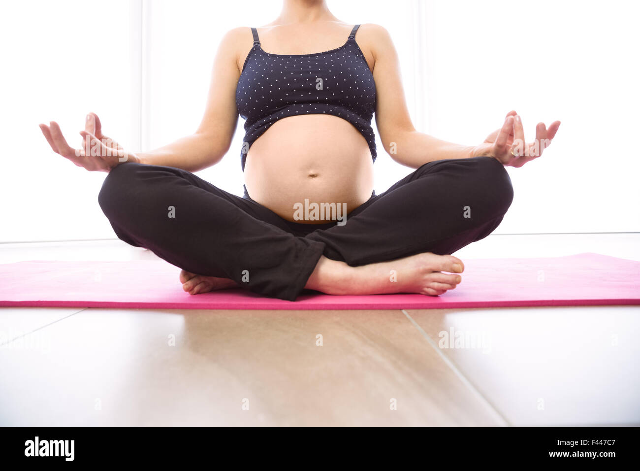 Pregnant woman keeping in shape Stock Photo