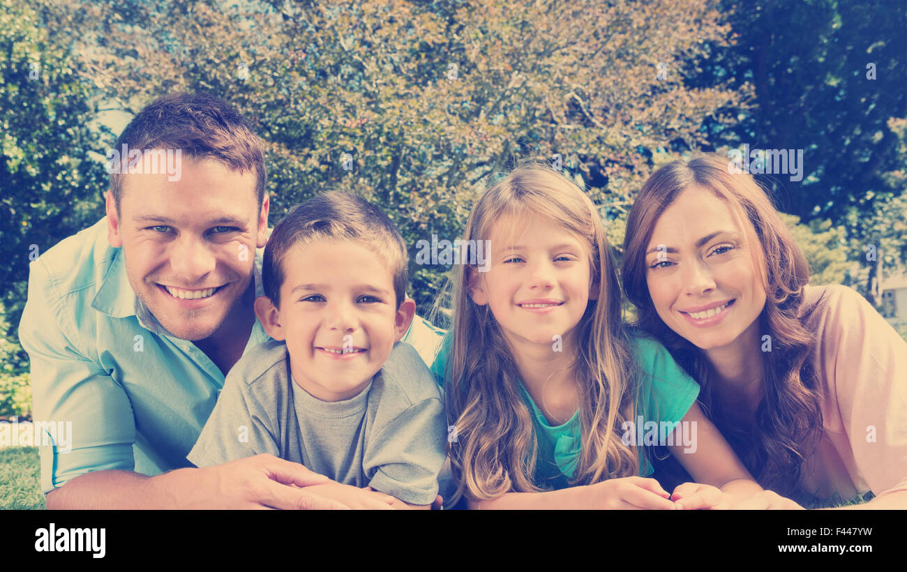 Happy family lying on the grass Stock Photo - Alamy