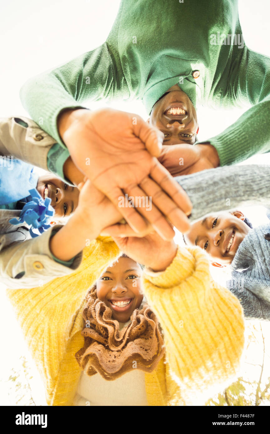 Young family doing a head circles and joining their hands Stock Photo