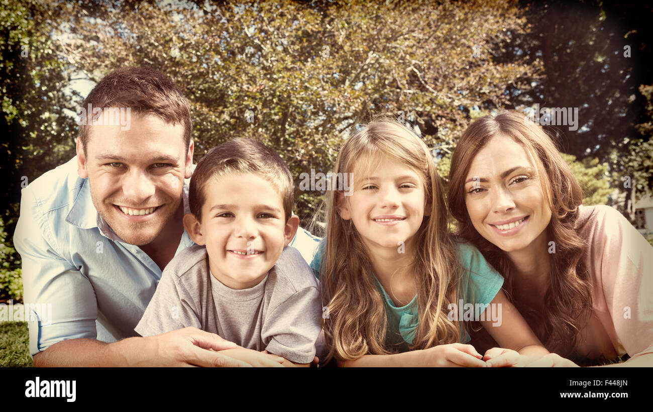 Happy family lying on the grass Stock Photo - Alamy