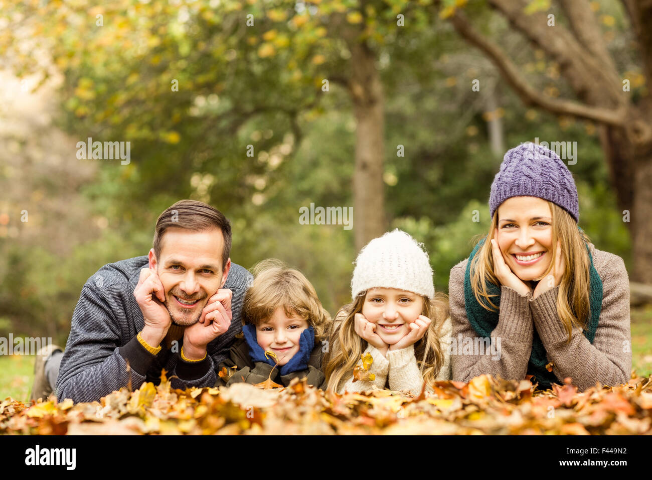 Smiling young family with hands on cheeks Stock Photo