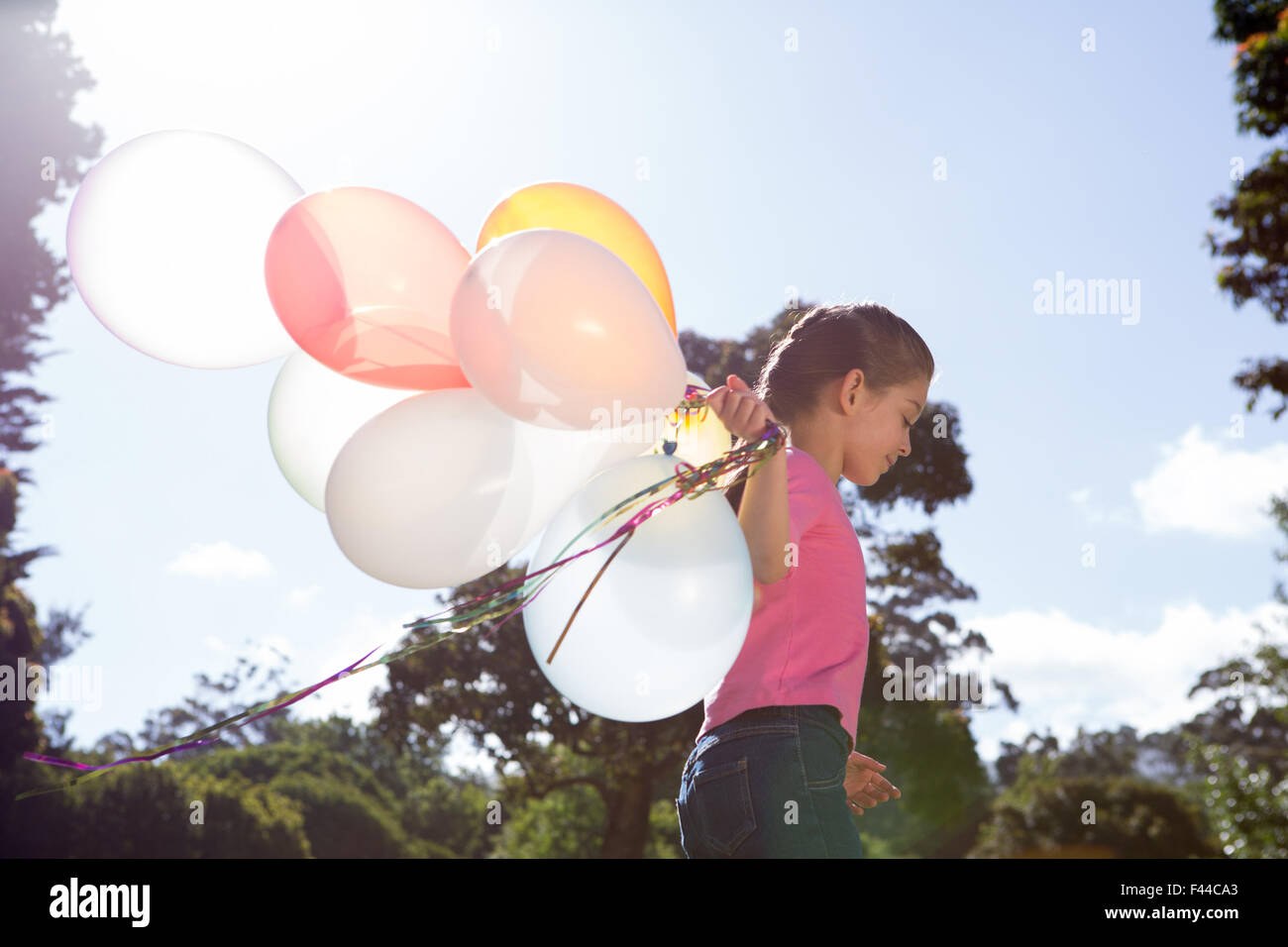 Happy little girl holding balloons Stock Photo Alamy