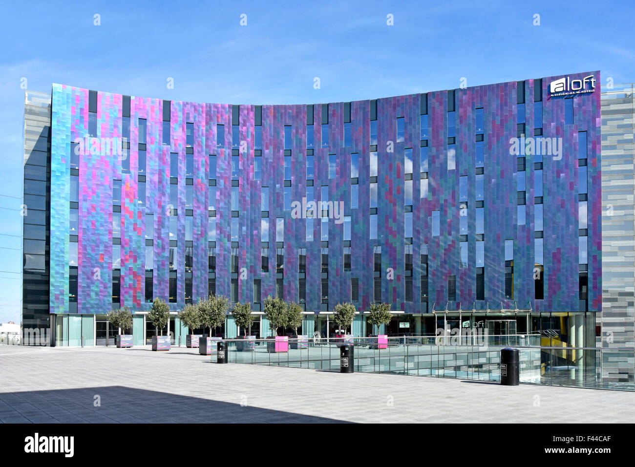 Hotel modern architecture colourful cladding panels on façade of aloft W hotel building adjacent to London Docklands Excel complex London England UK Stock Photo