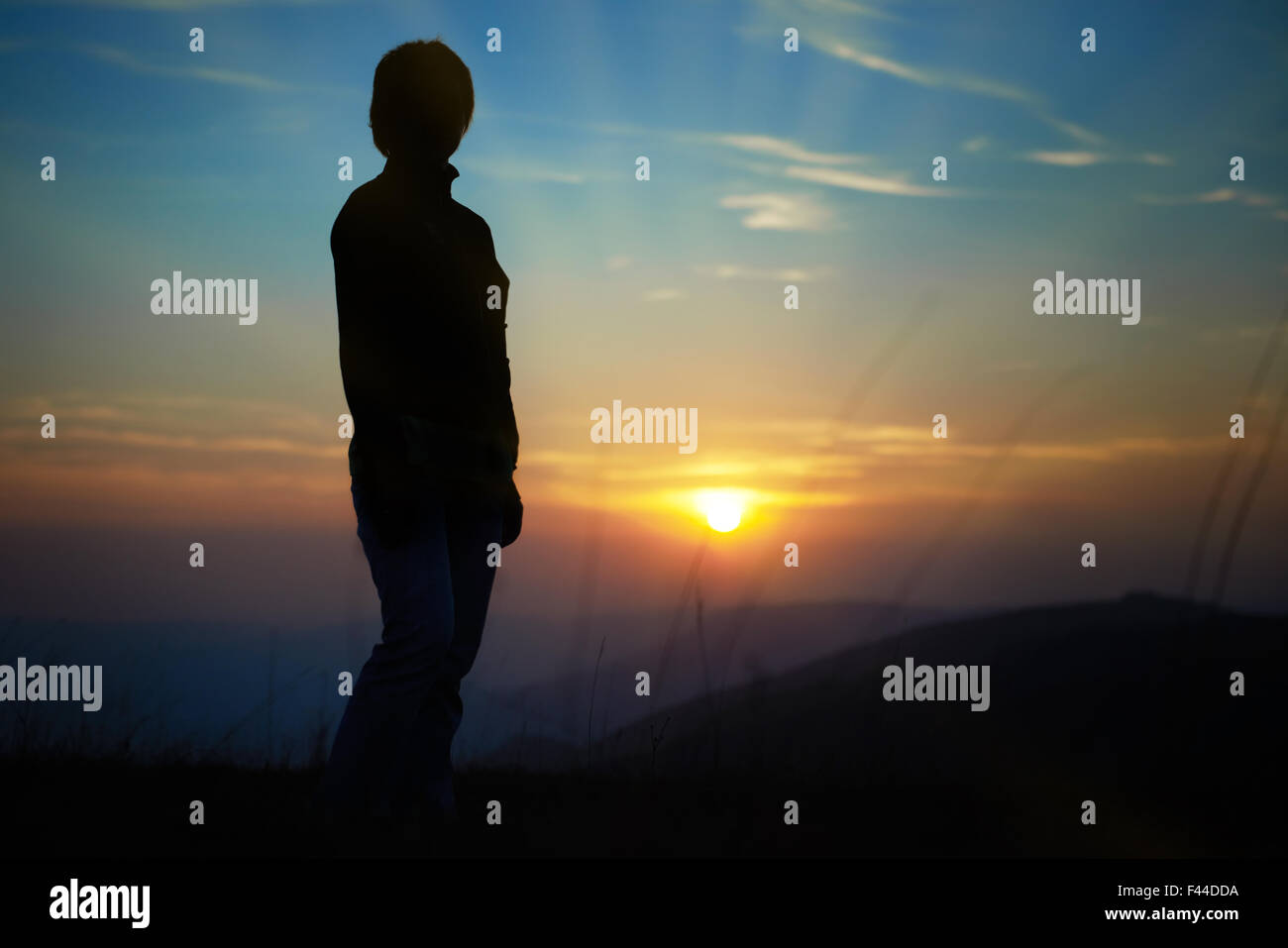 Silhouette of woman against sunset Stock Photo - Alamy