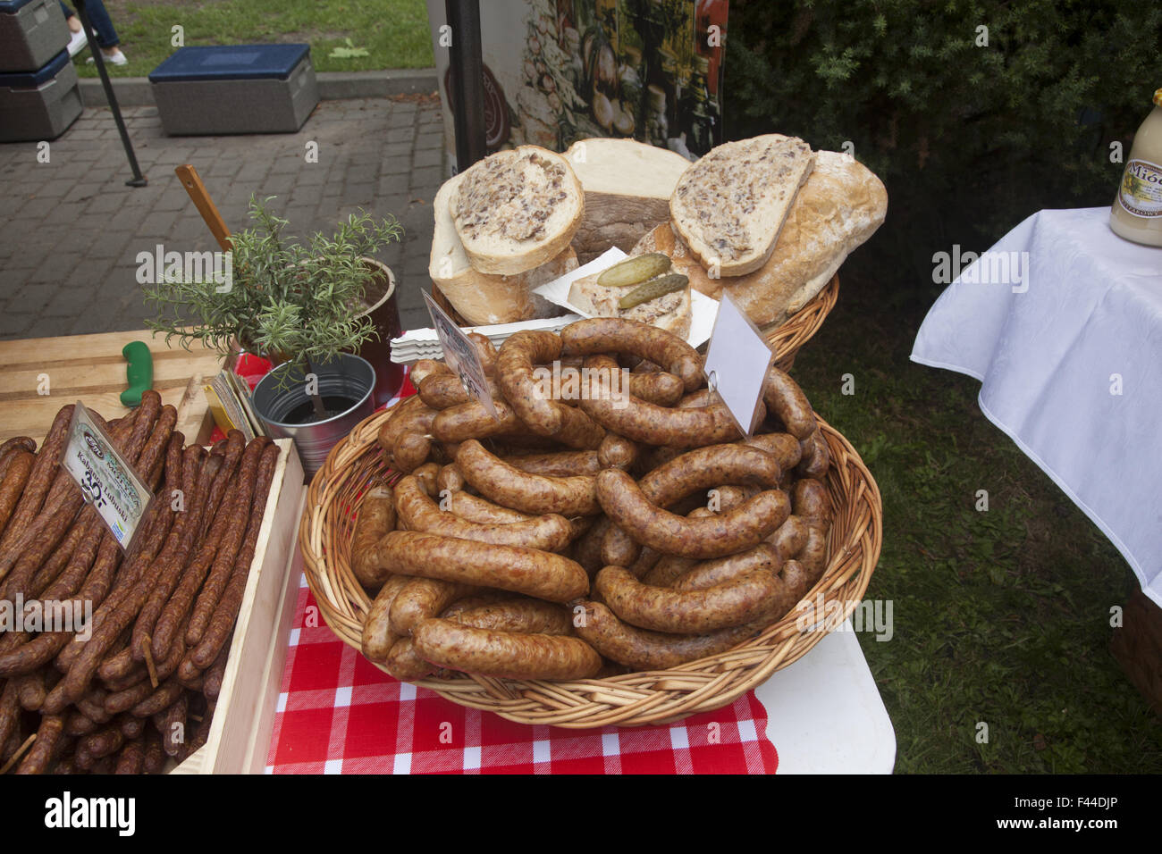 Various types of Polish sausage for sale at an outdoor festival near