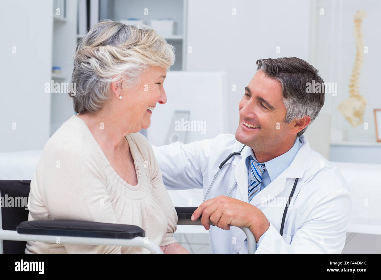 Male doctor looking at female patient Stock Photo - Alamy