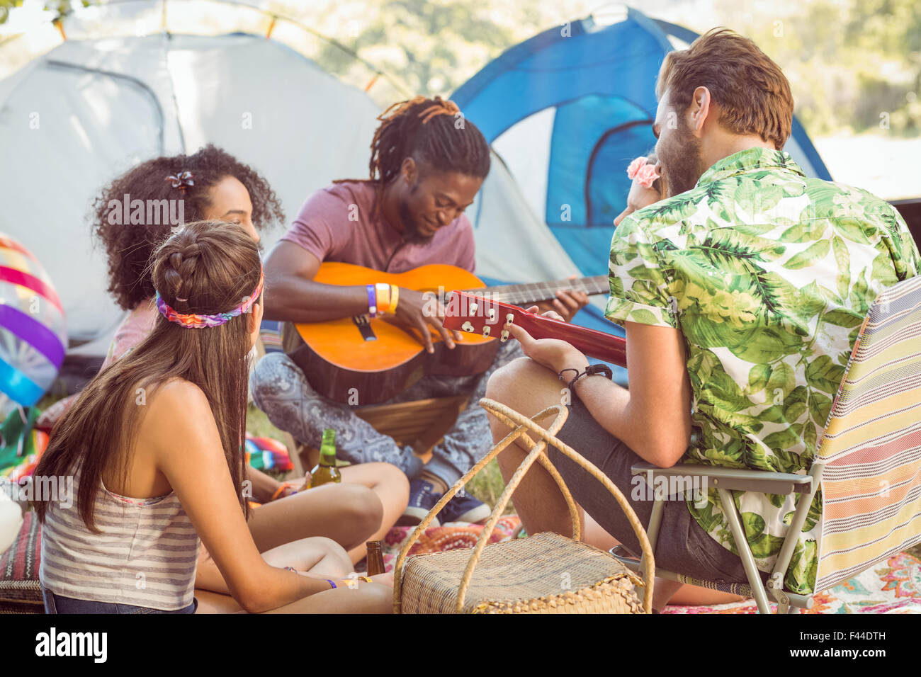 Hipster playing guitar for his friends Stock Photo