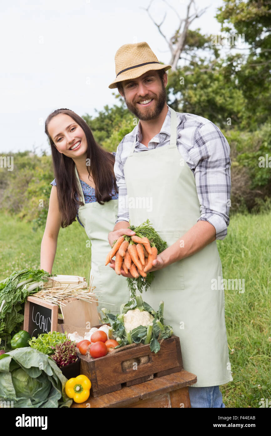 Couple selling organic vegetables at market Stock Photo - Alamy
