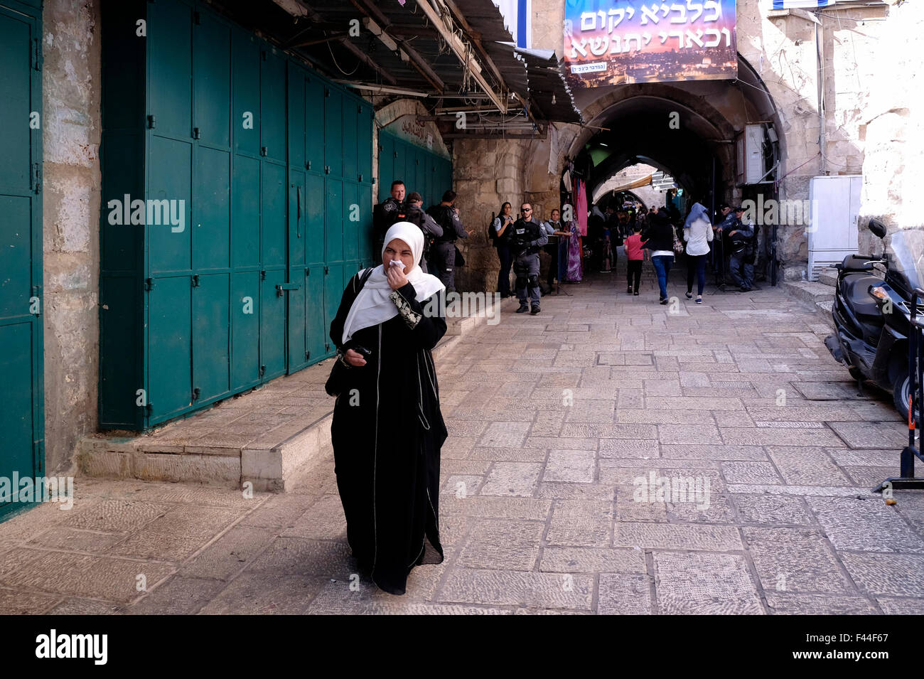 A Palestinian woman walk in Al Wad street which Israelis call Haggai in the Muslim Quarter, old city of Jerusalem Israel Stock Photo