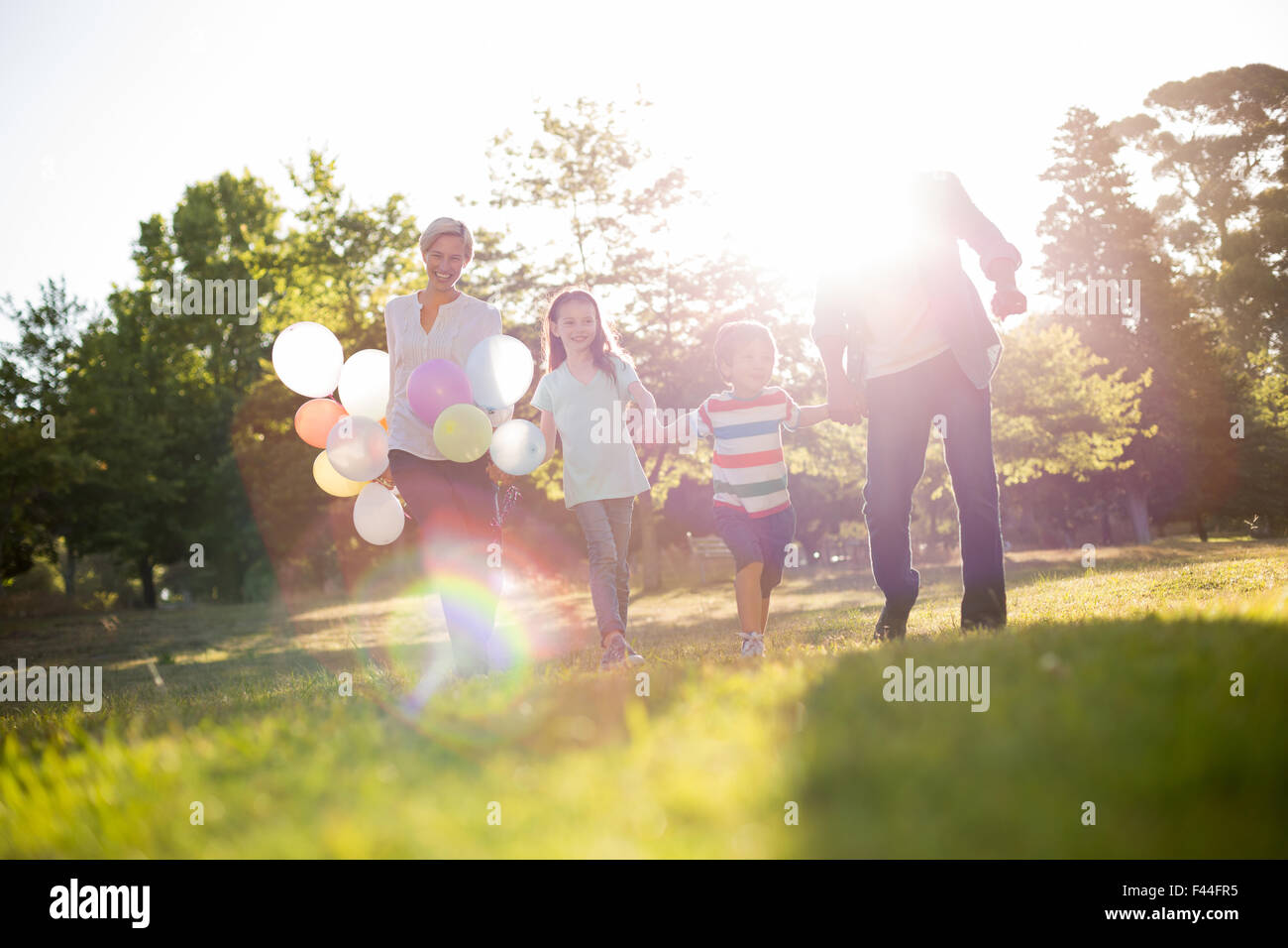 Happy family walking at the park Stock Photo - Alamy