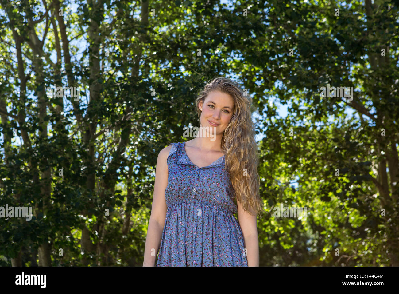 Pretty blonde smiling in the park Stock Photo - Alamy