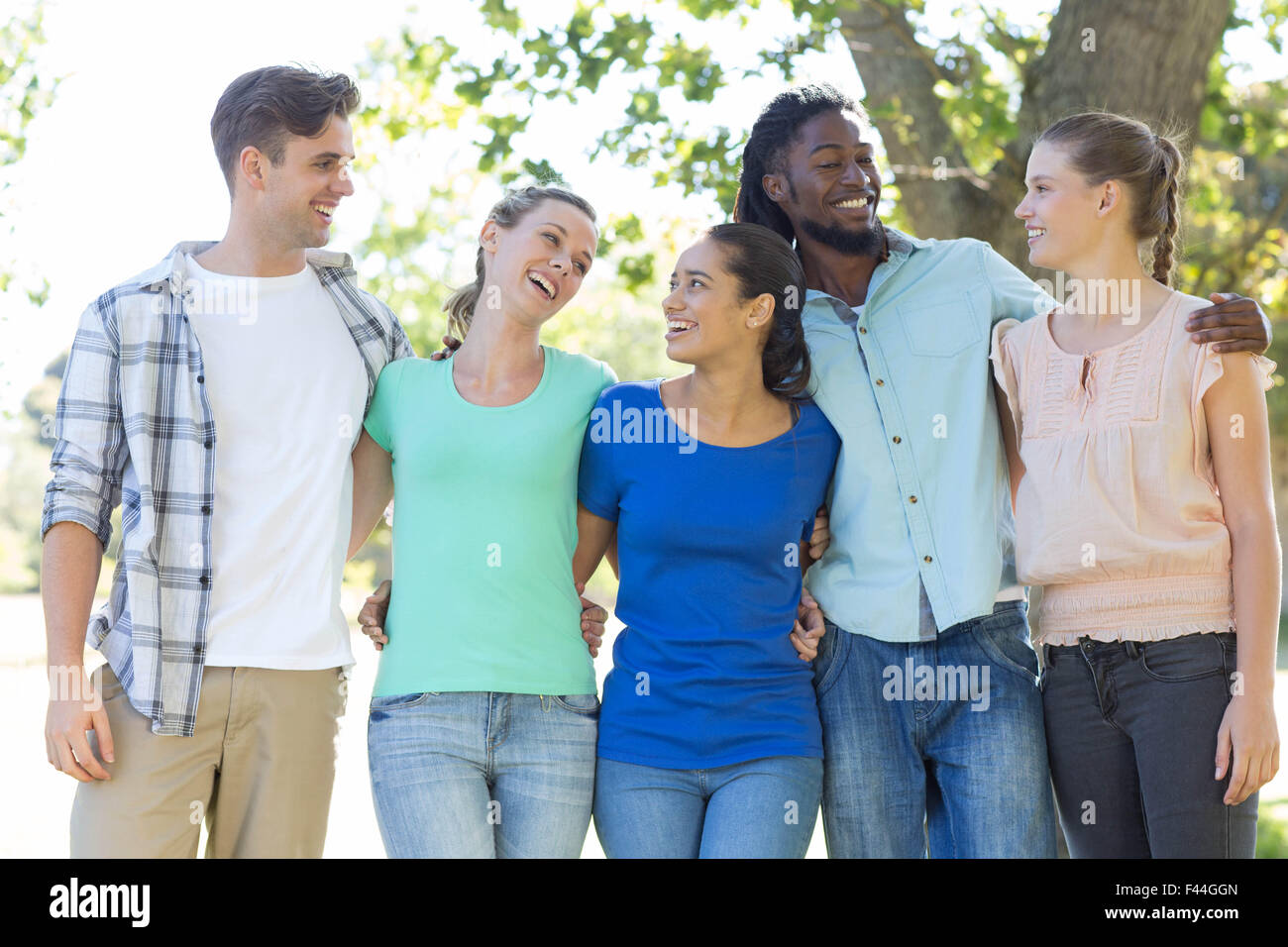 Happy friends in the park Stock Photo - Alamy