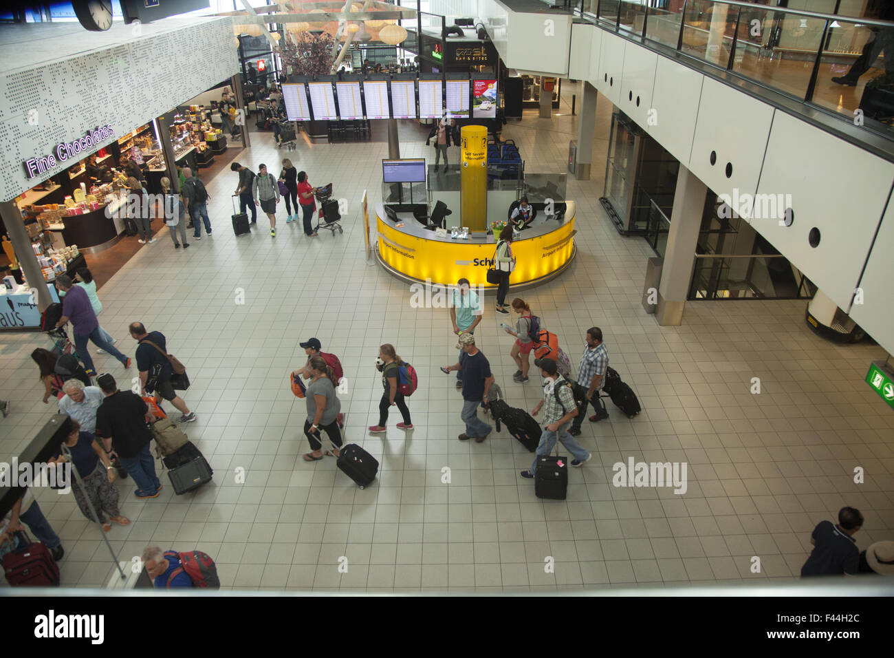 Travelers inside Shiphol International Airport in Amsterdam, Netherlands Stock Photo