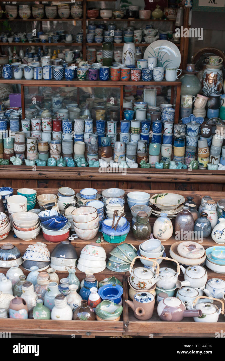 Many antique Japanese ceramic bowls tea kettles bottles and cups Stock