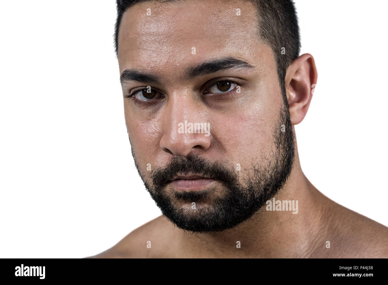 Muscular man frowning at camera Stock Photo
