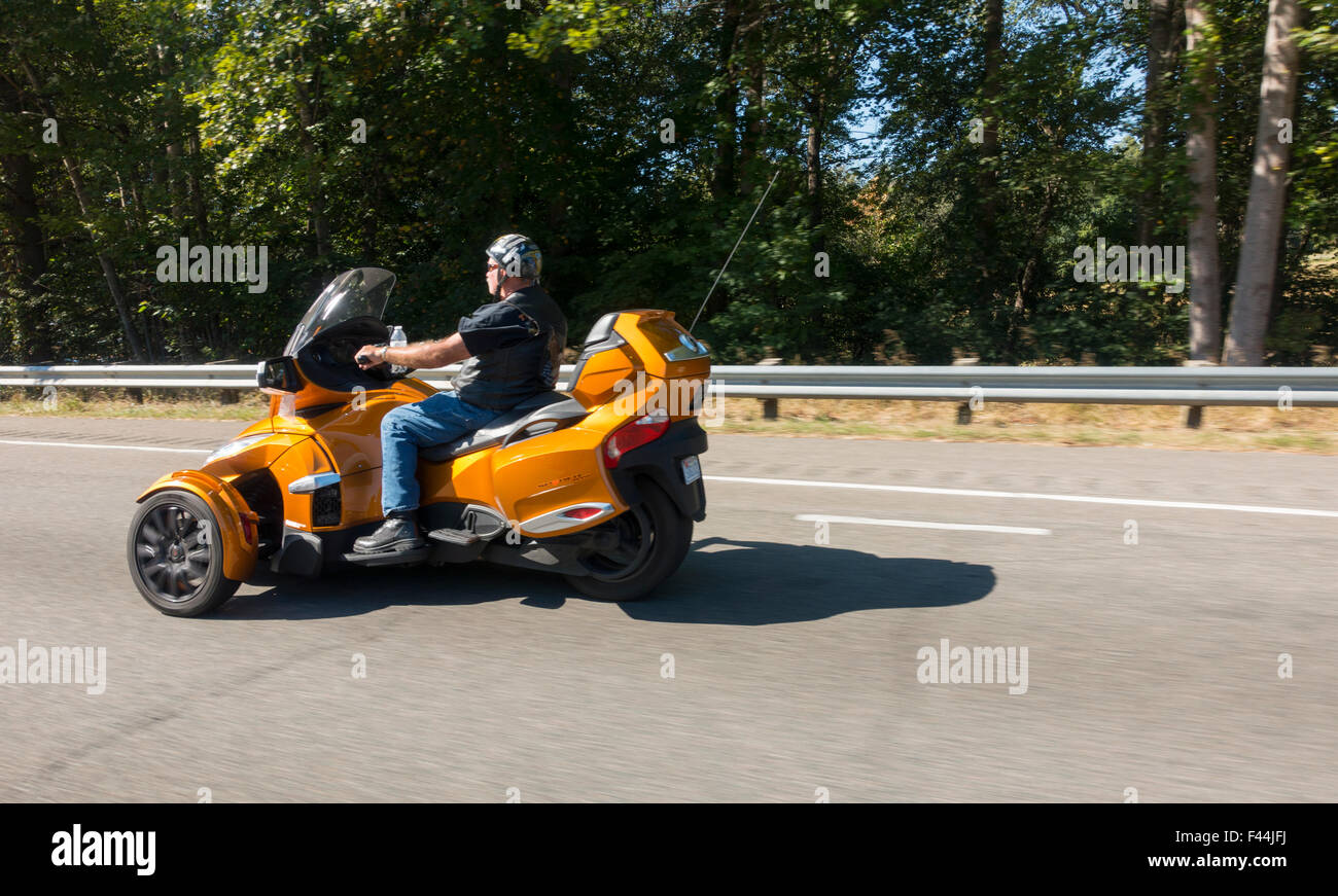 man riding three wheel motorcycle Stock Photo