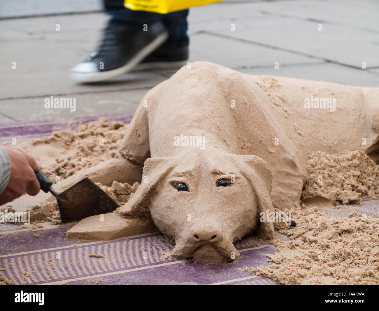 A dog made of sand a migrant in Oxford Street, Central London Stock Photo - Alamy