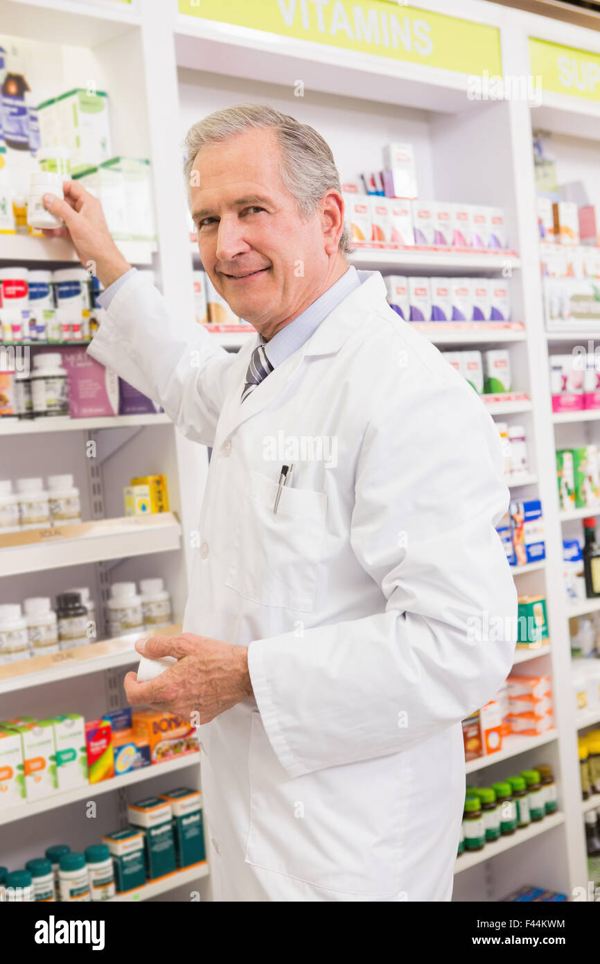 Pharmacist taking medicine from shelf Stock Photo Alamy