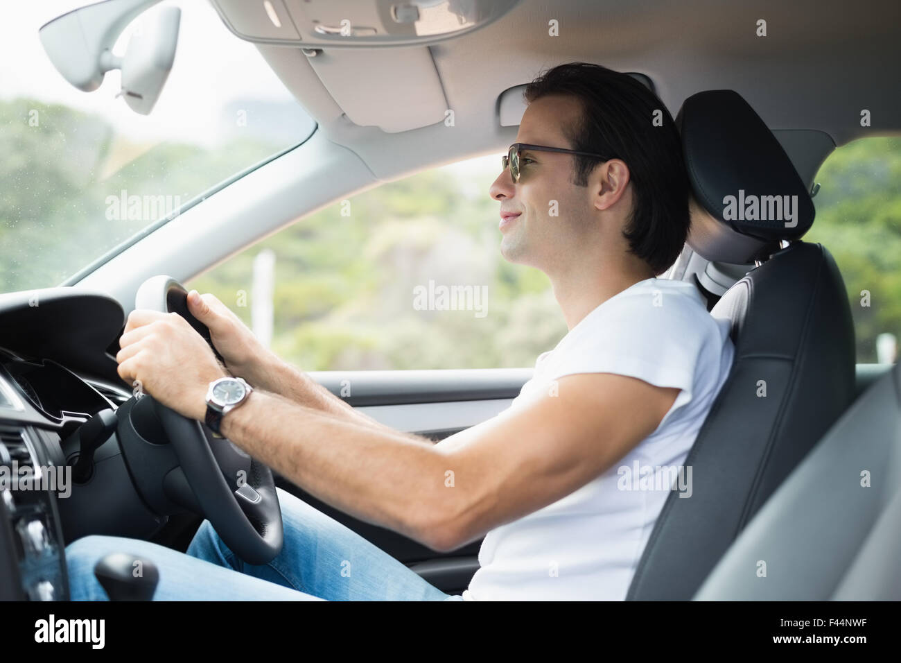 Man driving and smiling Stock Photo - Alamy