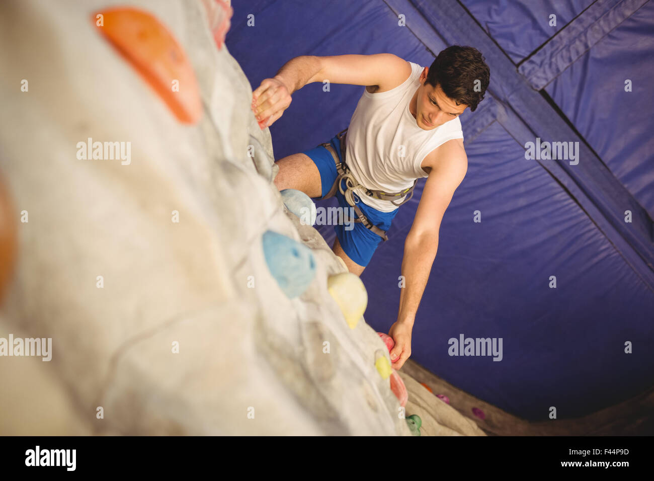 Man climbing up rock wall Stock Photo