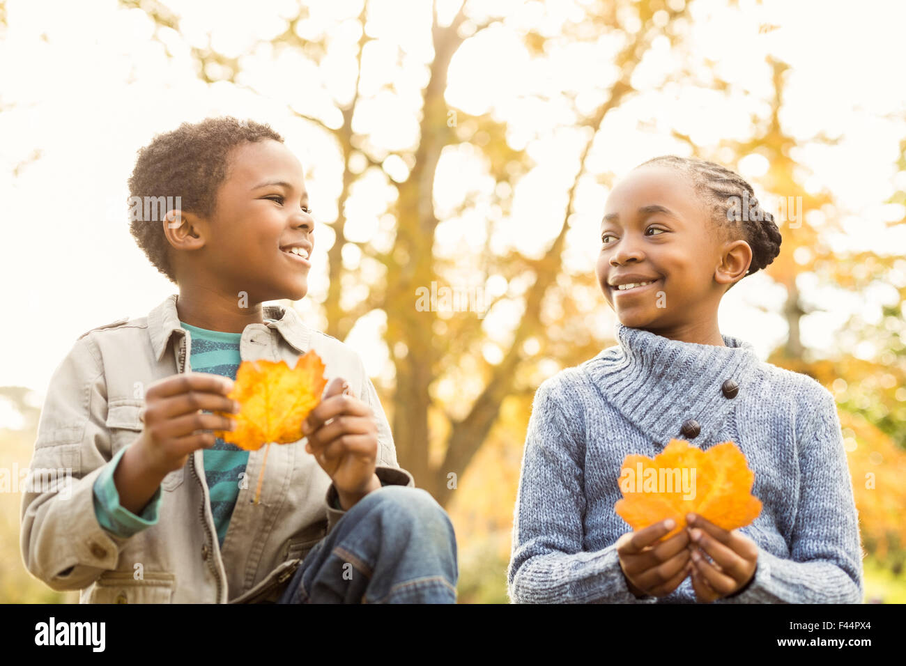 Portrait of young children holding leaves Stock Photo