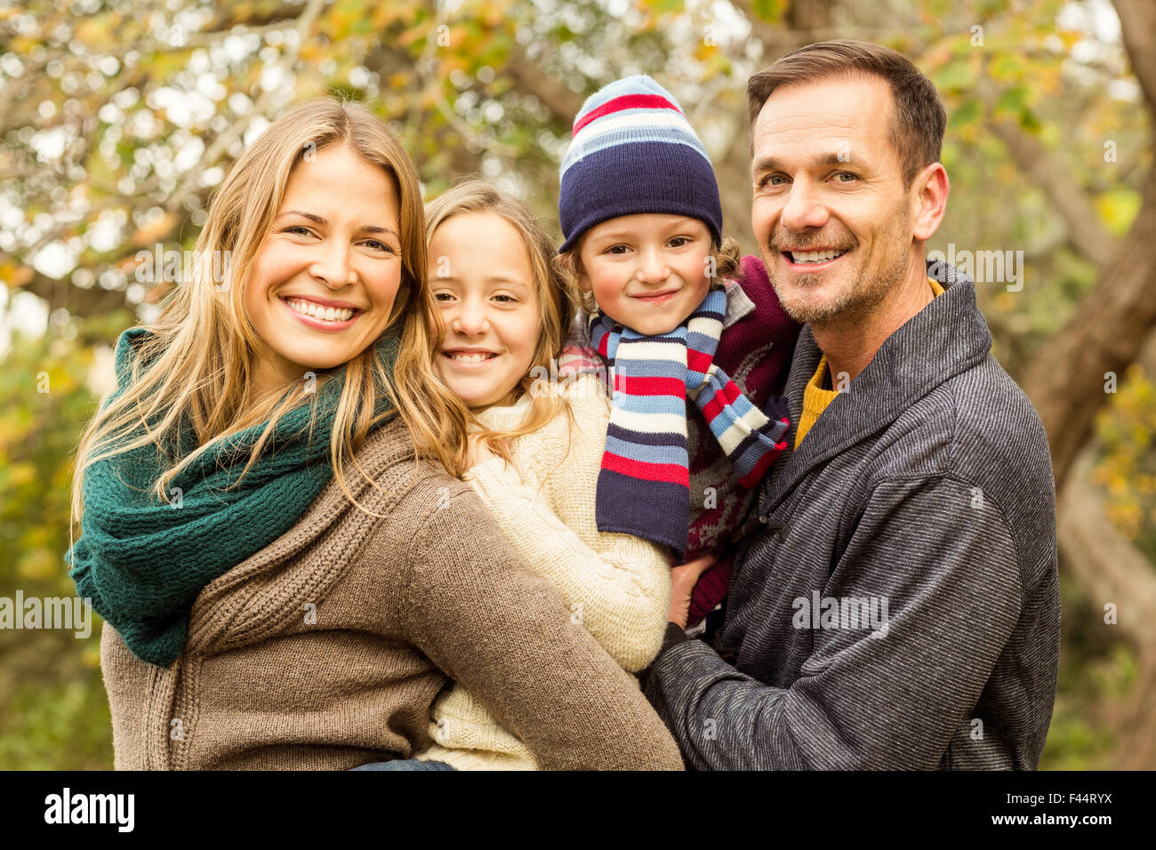Smiling young family posing together Stock Photo