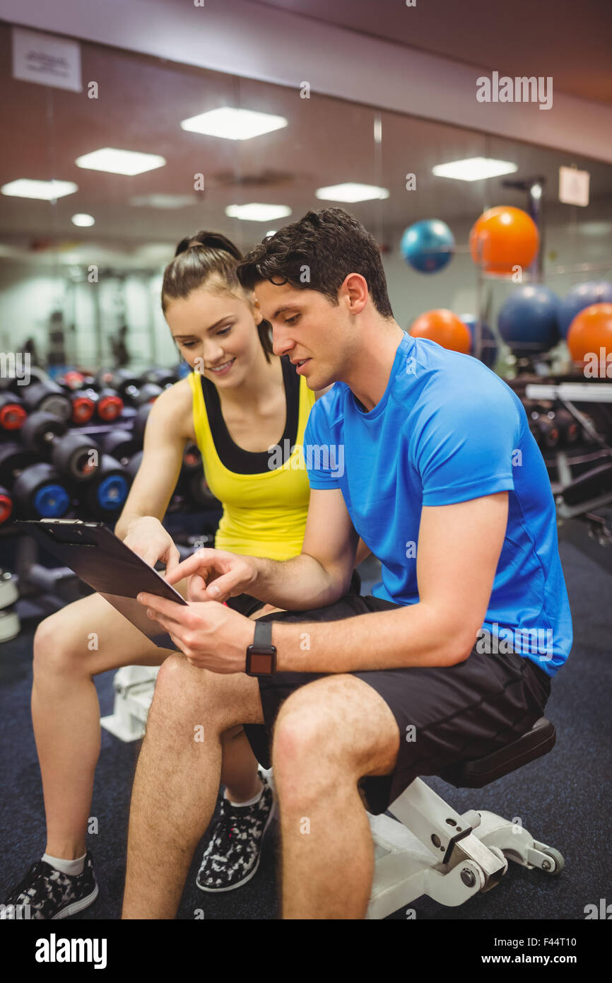 Trainer And Client Trainer and client discussing her progress Stock Photo - Alamy